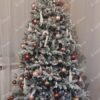 Snježno božićno drvce ukrašeno braon-ružičastim ukrasima