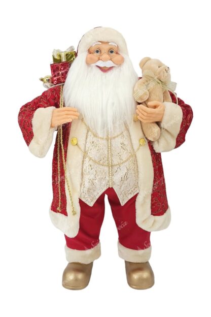 Dekoracija Santa Claus crveno-zlatni 80cm, ima crveni kaputić sa bijelim krznom, u jednoj ruci nosi igračku mjedvedića a u drugoj vrećicu sa poklonima